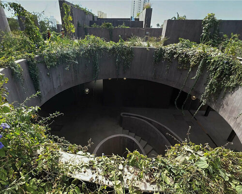 a lush flora engulfs tatiana bilbao's monolithic marine research center in mexico