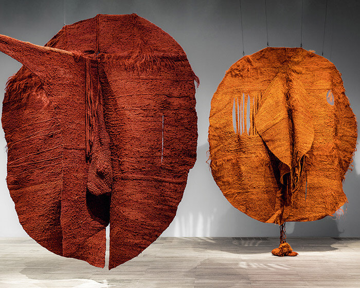 woven biomorphic sculptures by magdalena abakanowicz hover inside MCBA in switzerland