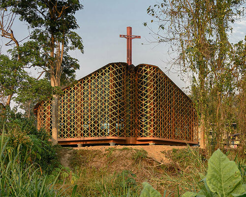 intricate timber latticework envelops st francis oratory amidst thailand's serene landscapes