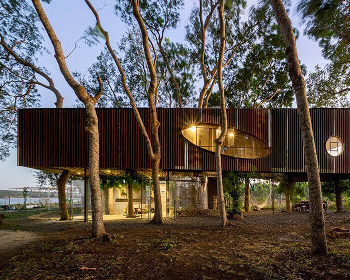 trees grow through this lakeside dwelling in vietnam by H2 architects