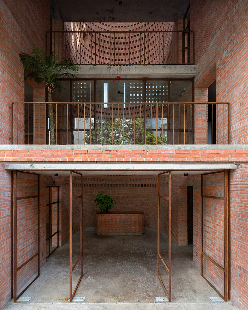 tropical space encloses 'premier office' with a porous brick facade