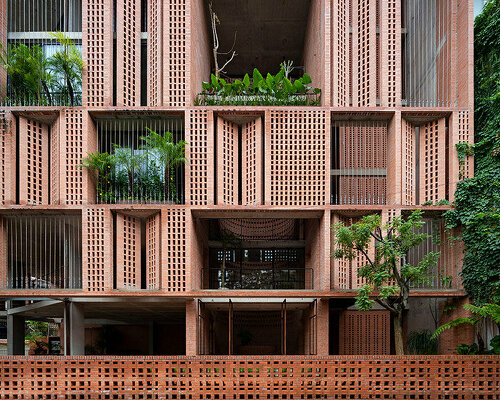 tropical space encloses this 'premier office' with a facade of porous brick shutters