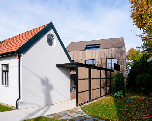 inlaid wooden board structure extends old 50s cottage in austria