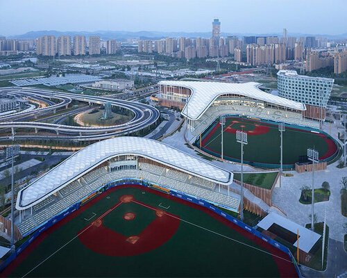 cloud-like winged roof floats above UAD's asian games sports cultural center in shaoxing