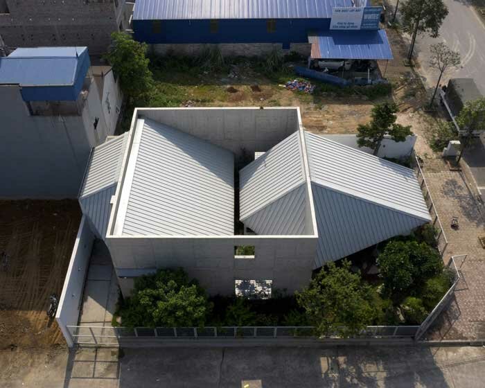 intersecting geometries form AHL architects' DHY house and café in vietnam