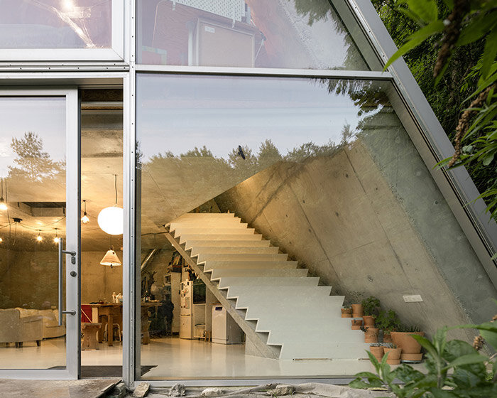 studeny architekti embeds concrete shell house into a hillside in pernek, slovakia