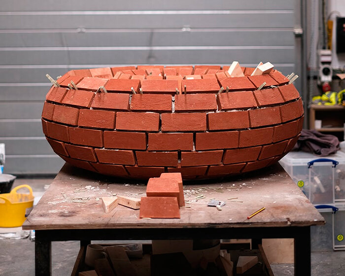 repurposed deadstock bricks compose round FLOAT bench on london's riverbank