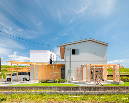 translucent plastic layers and timber frames expand house M in japan