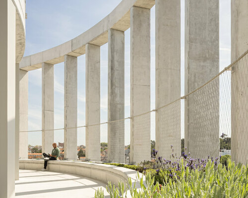 concrete pillars wrap around OODA's cylindrical student housing tower in porto