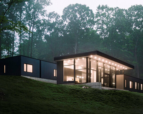 monochrome wood-clad house by studio mm nestles along sloped site in upstate new york