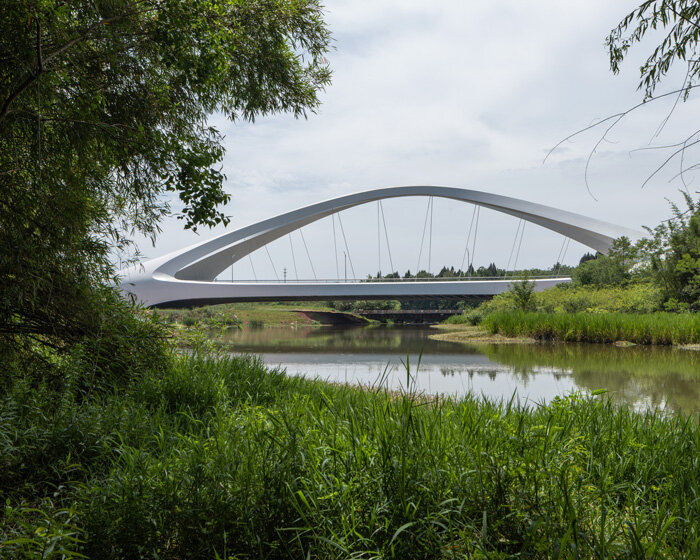 zaha hadid architects sculpts double-arched symmetrical bridge across jiangxi river in china