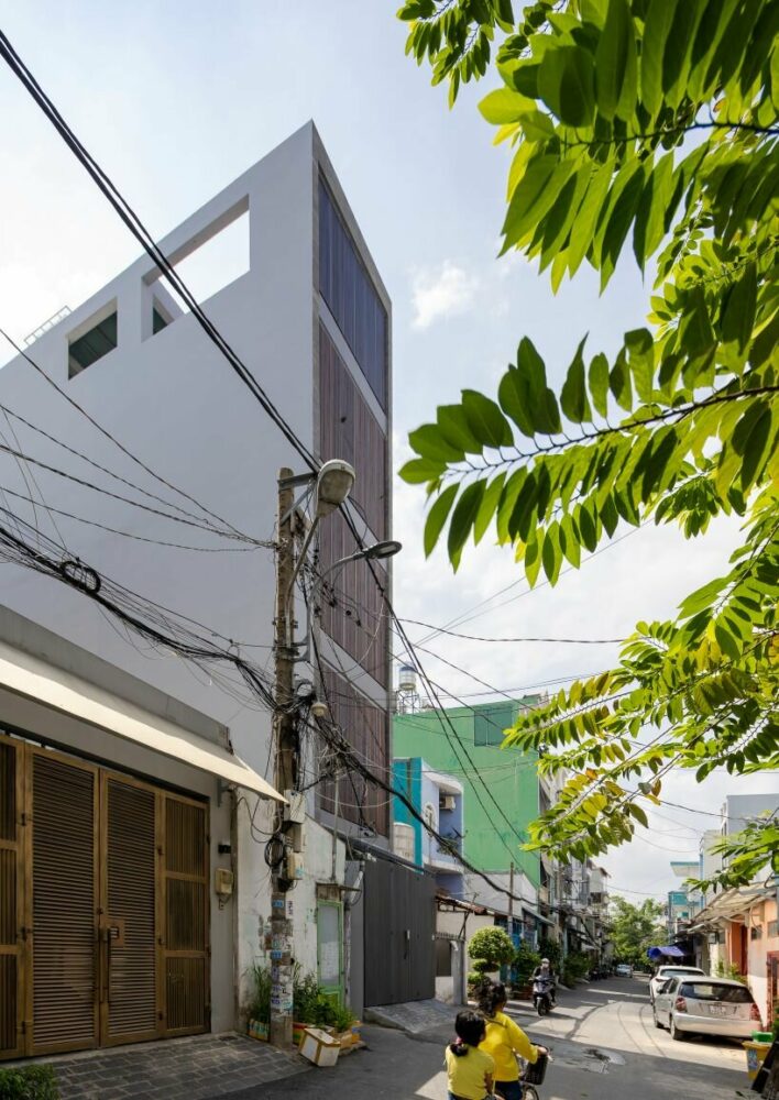 folding teak shutters envelop pham trung's narrow home in vietnam