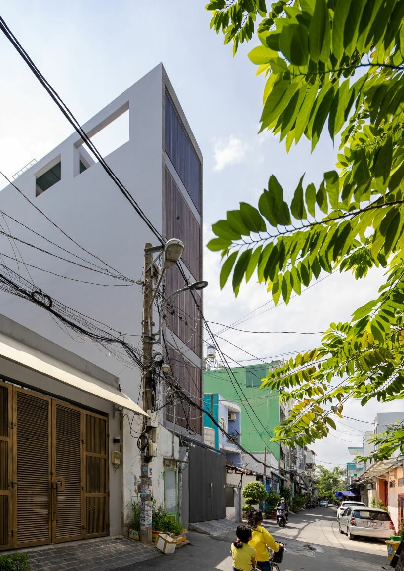 folding teak shutters envelop pham trung's narrow home in vietnam