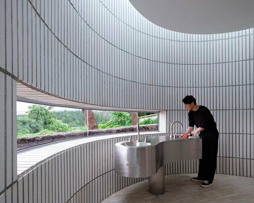 ceramic tiles coat the rounded form of jungmun catholic church unit in south korea