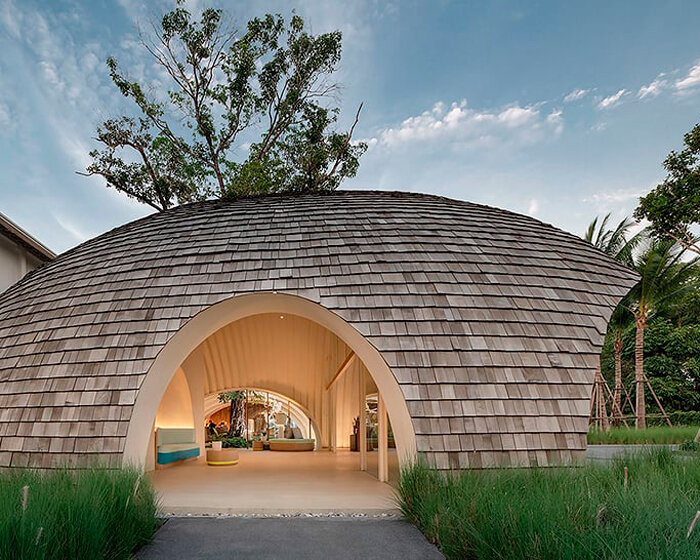 onion designs hotel's dome-shaped lobby clad in wooden shingles in thailand