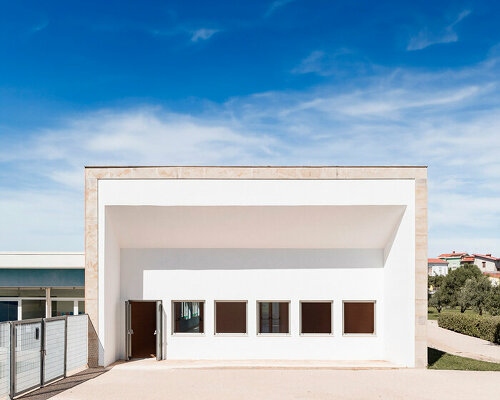 vibrant multipurpose room breathes new life into kindergarten in italy