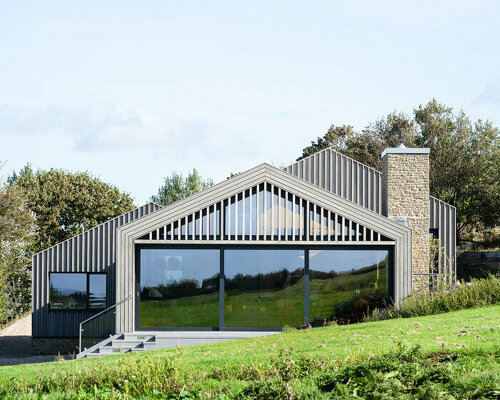 cluster of pitched timber volumes by coffey architects perch above dorset's sloping hillside