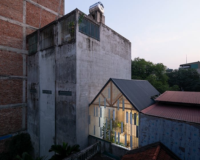 translucent sheets wrap raincoat house's facade and roof in vietnam