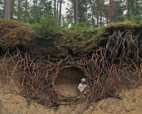 UMA's sprawling root hut installation engulfs visitors in a curtain of branches and moss