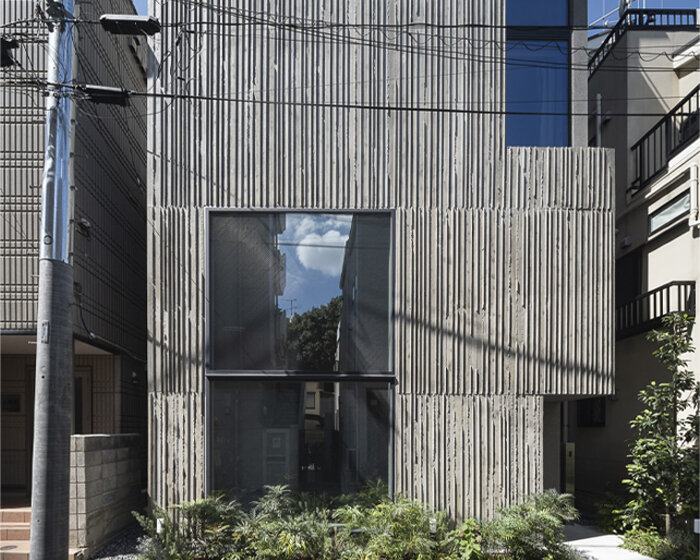 K+S architects fronts home-office in japan with textured concrete evoking geological layers