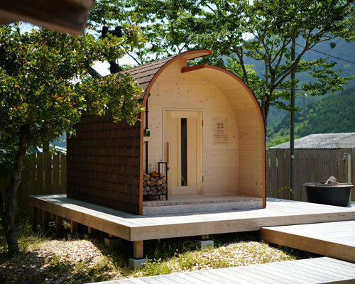 thinned trees from japanese forest compose barrel-shaped sauna with stepped ceiling