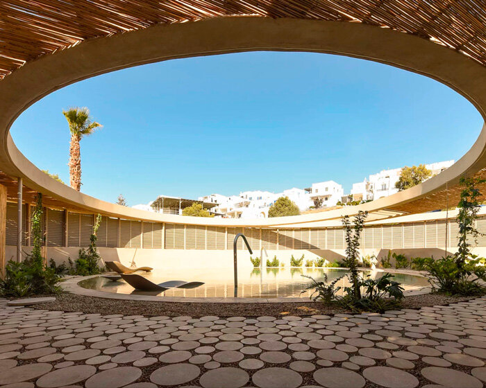 cubic and circular volumes develop around resort's swimming pool in greece