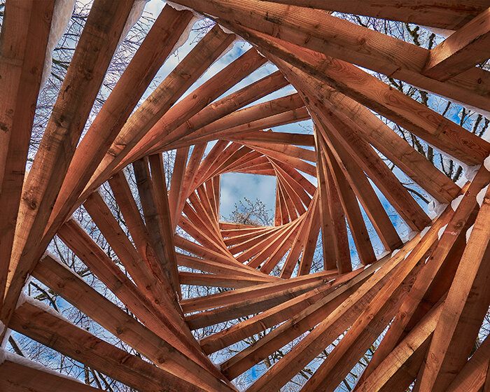 davide macullo's interwoven timber pavilions nestle in the swiss alps woodland