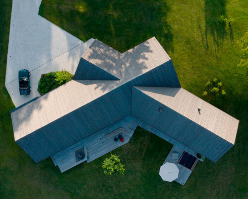 two intersecting saddle roofs shield DMAA's house f in slovenia