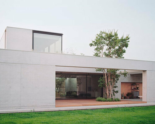 exposed concrete volumes and sliding wooden shutters compose house nf in italy