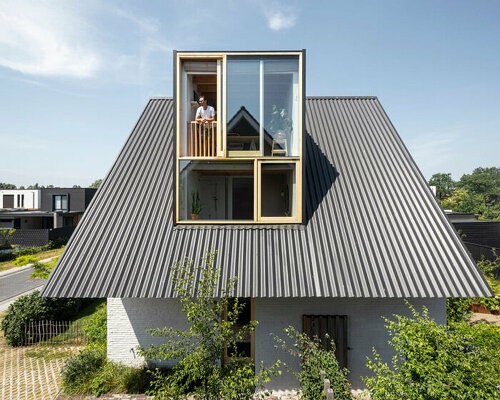 an overhanging roof and encircling garden nestle 'lime wash house' in the netherlands