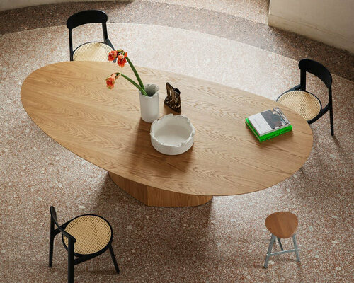 curving tabletops perch atop a monolithic, leaf-shaped base for miniforms' monoplauto table