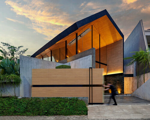 expansive gable roof hovers above RAD+ar's bernaung house in indonesia