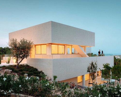 fluted concrete walls sliced by continuous glazed openings shape up shift house in spain