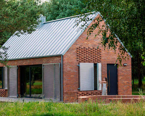 patterned brick facade and metallic shutters envelop forest house in poland