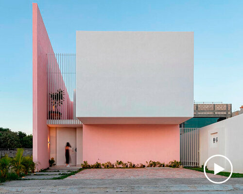 pink-hued sculptural wall emerges as casa banderas' west-facing facade in mexico