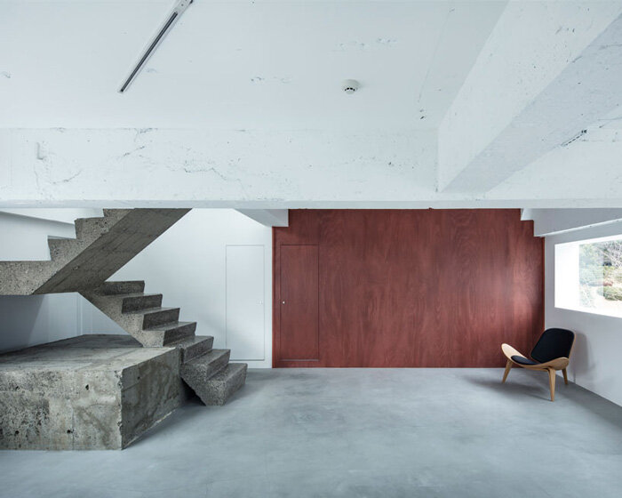 sculptural concrete staircase and distorted mirrors enliven minimalist photo studio in tokyo