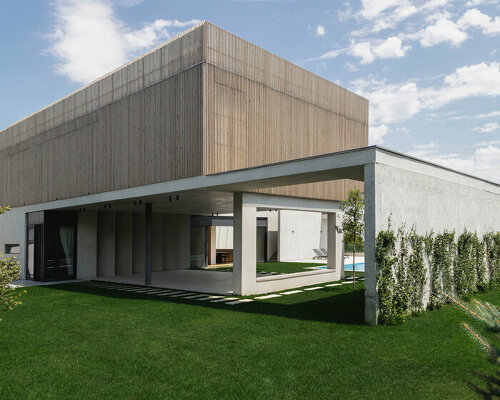 vertical wooden foldable louvers sit atop of residence's concrete volume in georgia