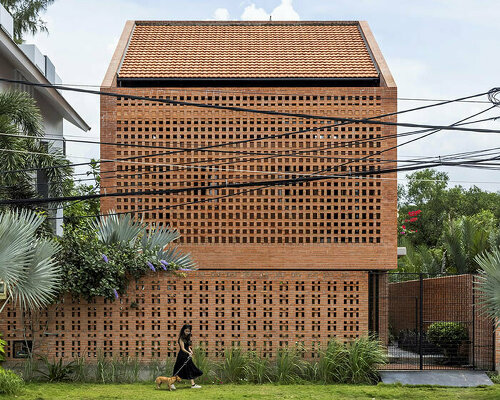 a perforated brick facade veils tropical space's nhà bè house in vietnam