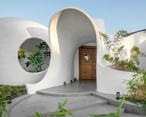 the grid architects' pravaah workspace in india curves and flows around native flora