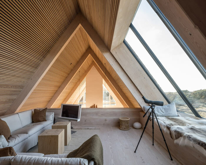 a thatched roof floats over PAX architects' skagen klitgård house in denmark