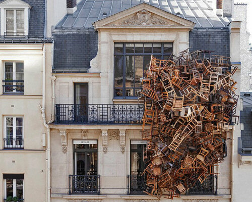 tadashi kawamata nests a tower of wooden chairs onto liaigre's parisian mansion facade