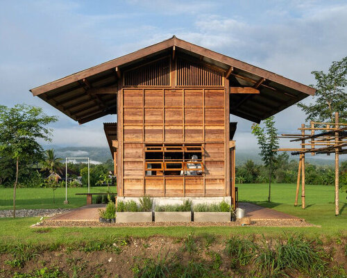 rice barn-inspired cafe by yangnar studio sits amid a paddy field in chiang mai