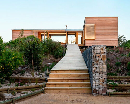 timber-clad residence by klg architects emerges from the dunescape in south africa