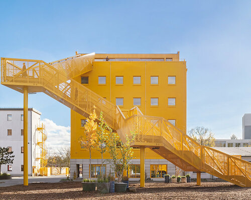 MVRDV's yellow grand staircase marks atelier gardens' new central hub in berlin