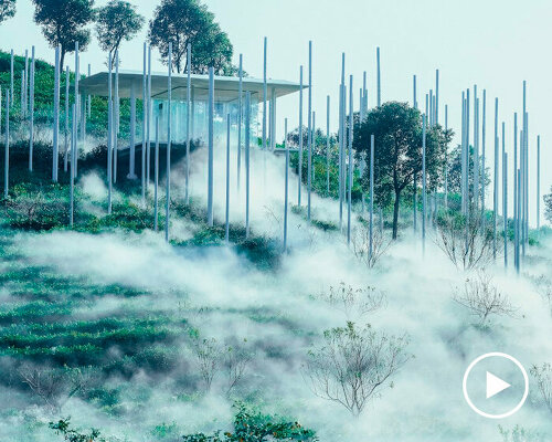 cloud tea room emerges from chinese hillside along with white steel poles infusing fog