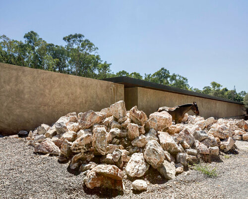 manuel cervantes estudio carves a horse track and stables in puebla's rocky terrain