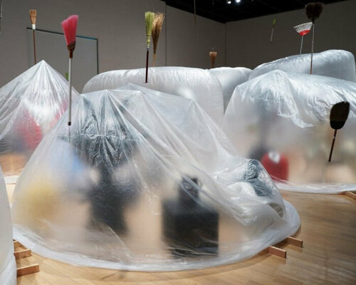 yasuaki onishi's installation wraps sculptures in inflating and deflating sheet bags in japan