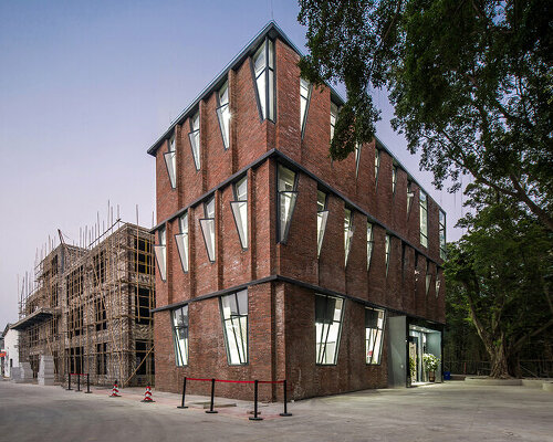 red brick facade with angular windows enfolds multi-use building in china's art district