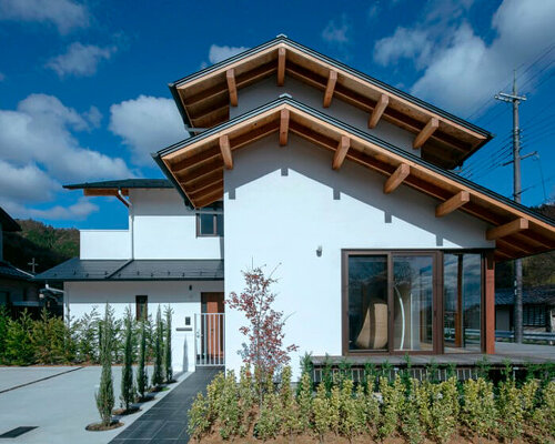 double gable roof tops house in kyoto reflecting the mountainous backdrop