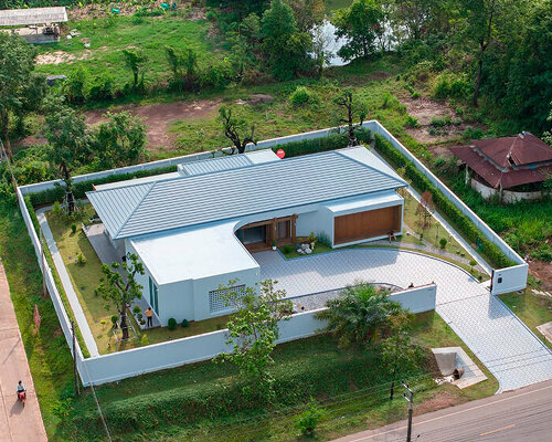 wooden folding blinds invite greenery within private residence's interior in thailand